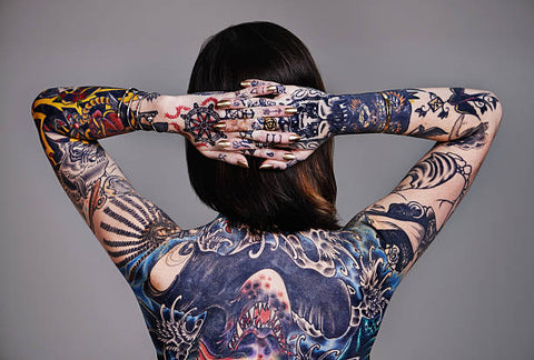 large back tattoo on a slender female body