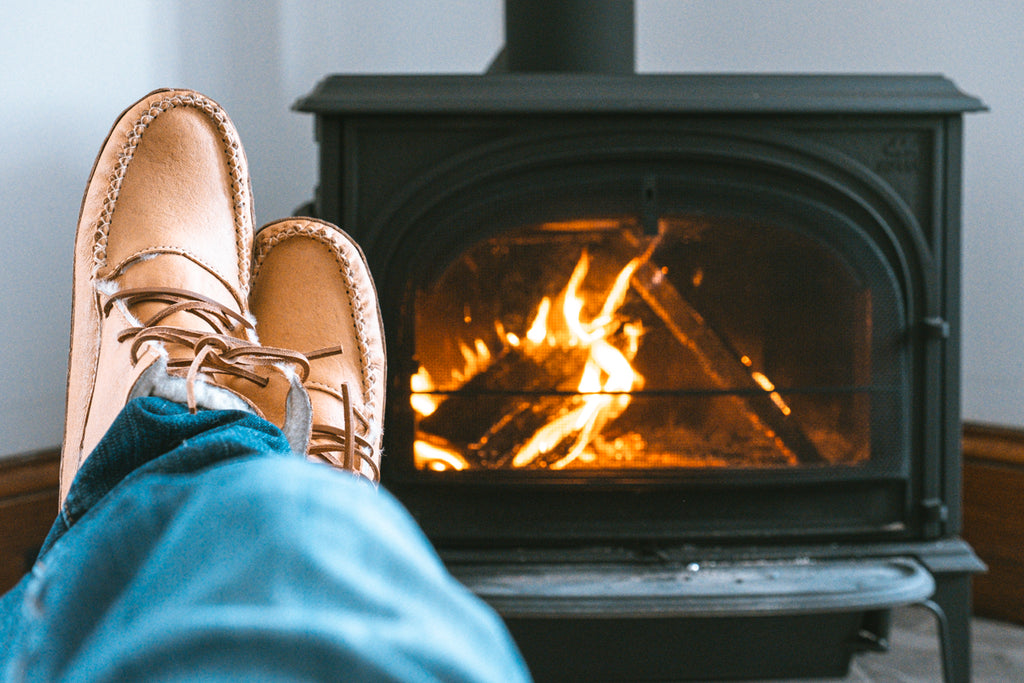 cozy moccasin boots by the fire