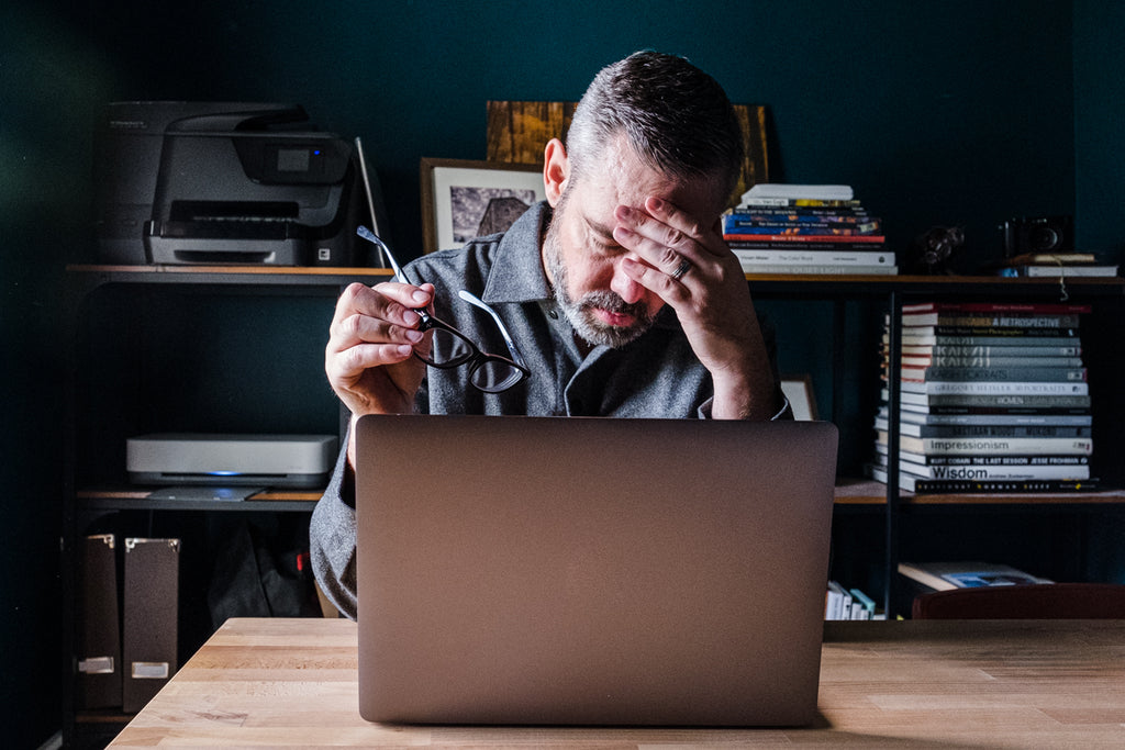 stressed out at a computer screen working headache