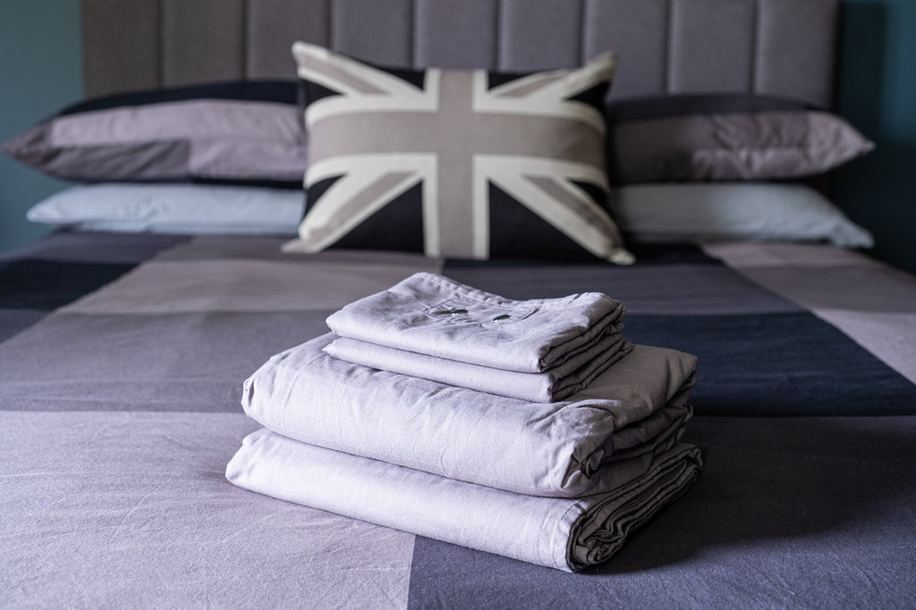picture of grey sheet set on a bed