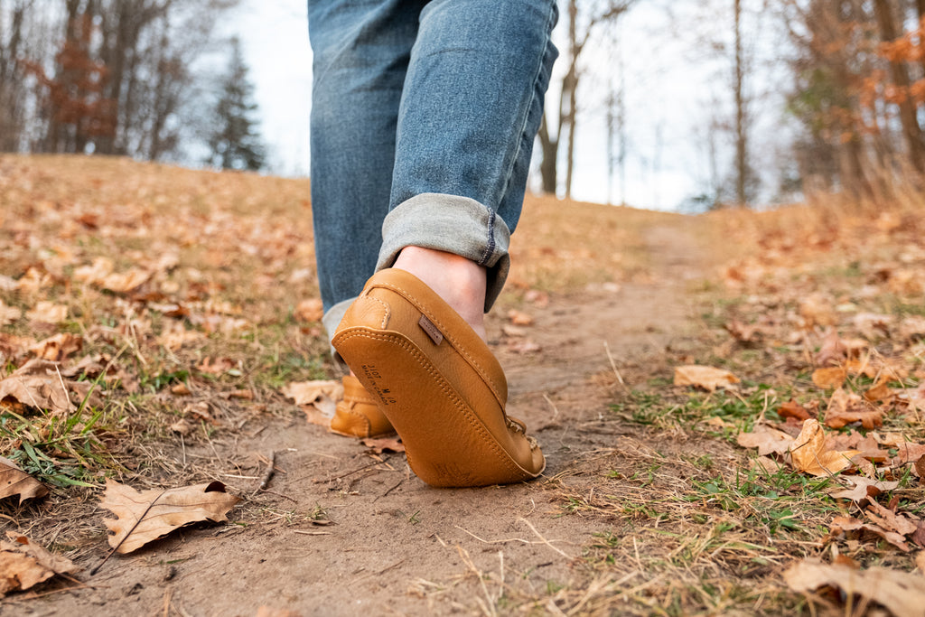 Earthing, walking in leather moccasins are barefoot on the ground