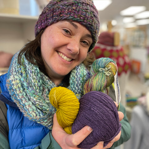 Loraine holds three colors of yarn for her Shift