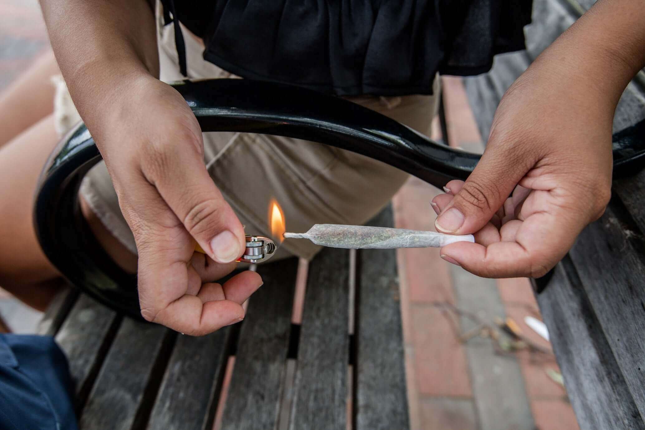 Person lighting a pre-roll joint