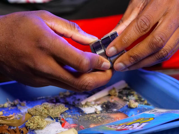 man grinding up cannabis