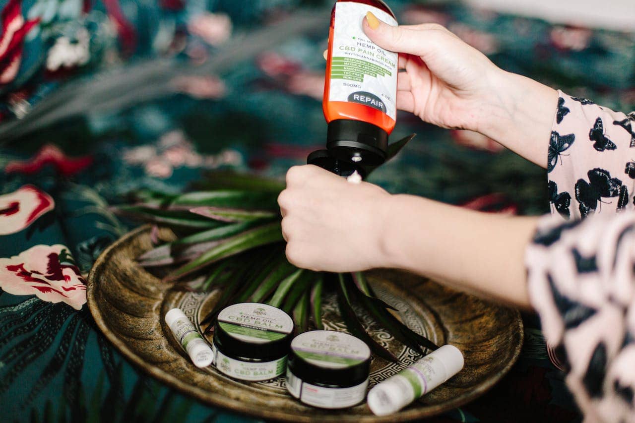 Woman applying CBD lotion to her hands