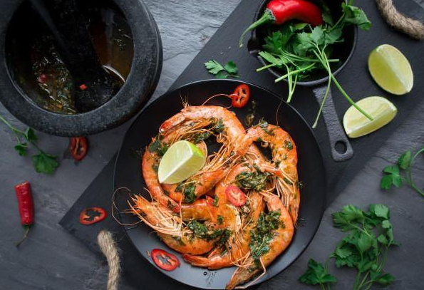 head on prawns on a plate with a pestle and mortar 