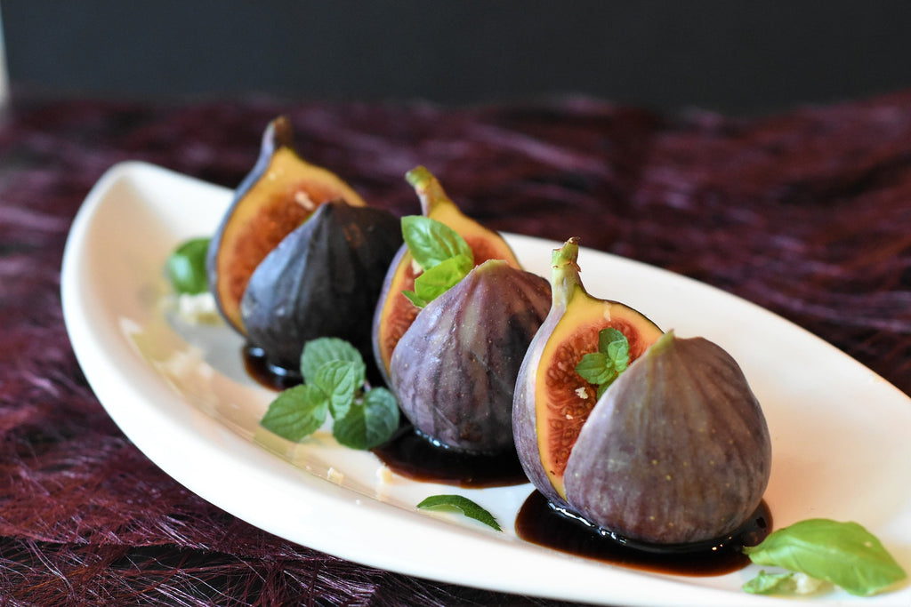 a plate of three figs with balsamic vinegar 