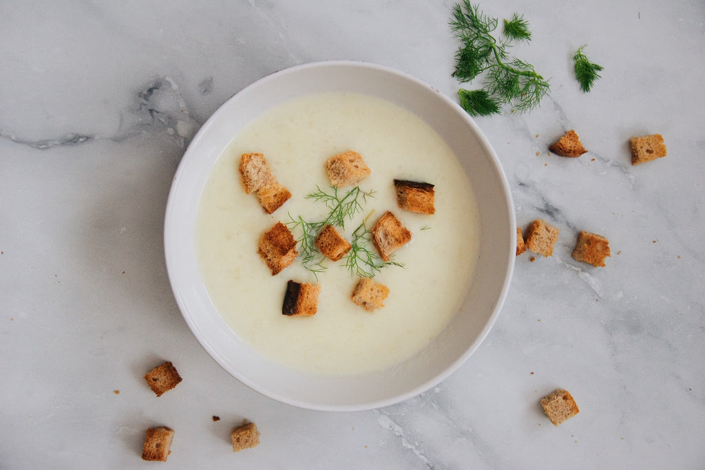 creamy soup with croutons seen from above 