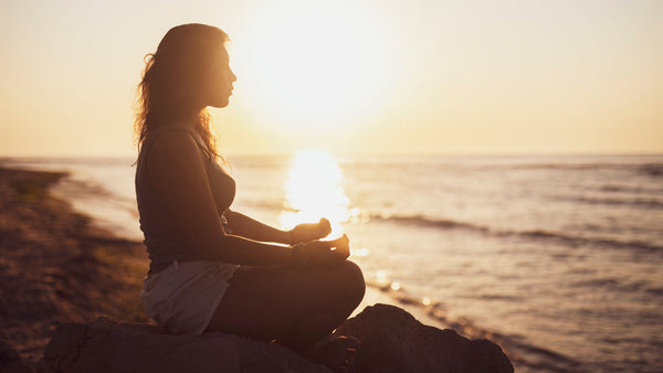 Pre-Surf Meditation and Breathwork - Woman on beach meditating