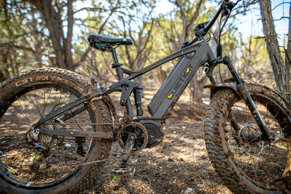 Profile view of a QuietKat electric bike frame covered in mud