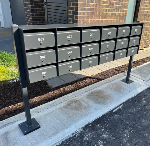 multibank letterboxes posts bolted to concrete