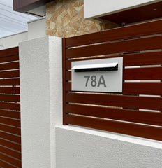 superior letterbox surfmist vinyl silver numbers in metal slat fence
