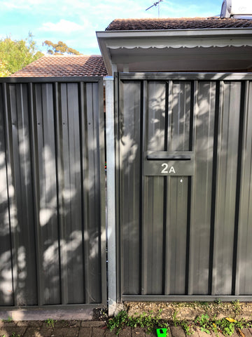 superior letterbox in corrugated metal fence