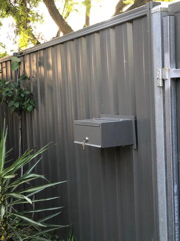 superior letterbox in corrugated metal fence back