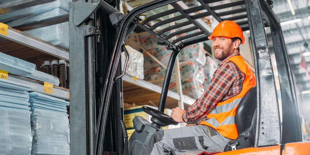 people wearing safety vests can operating forklift in a warehouse