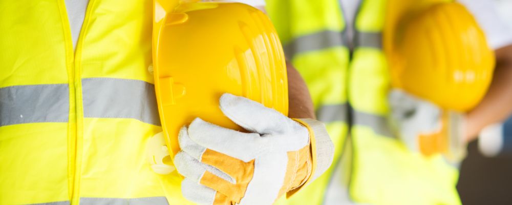 worker with safety vest and helmets