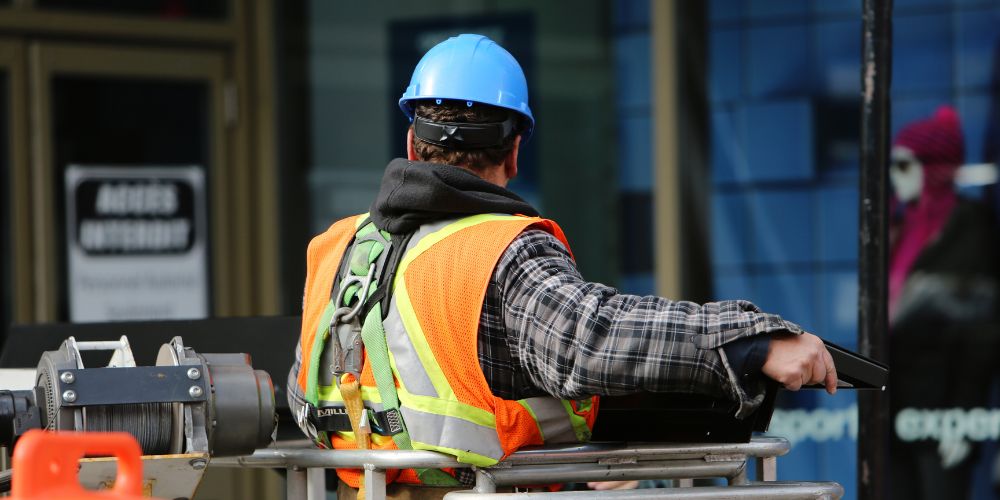 construction worker wearing safety vest for enhance visibility