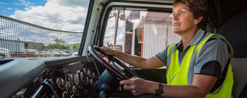 women wearing safety vest operating a truck