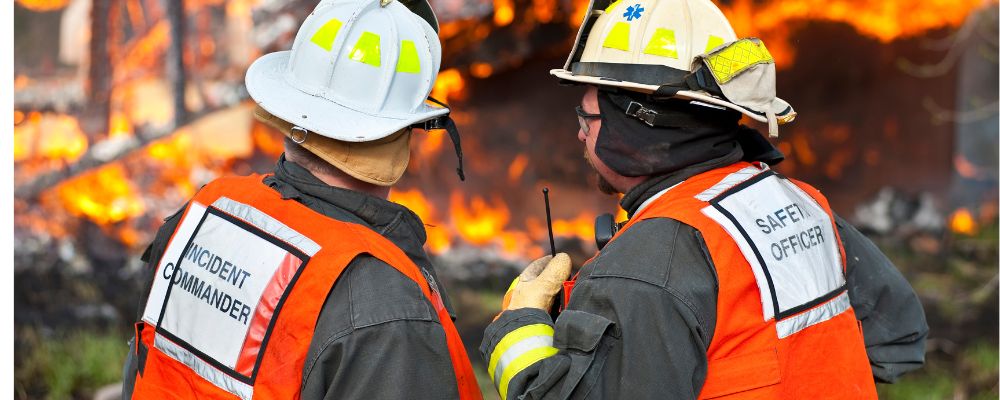 two man wearing fire resistance safety vests