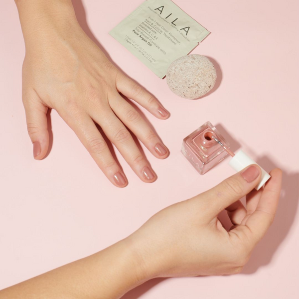 Woman applying nail polish using a dry manicure method