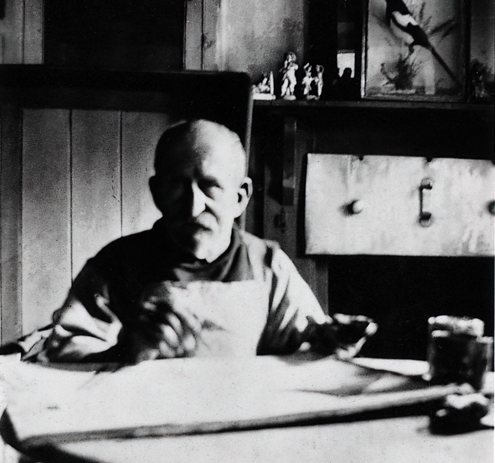 photograph of Cornish Artist Alfred Wallis sitting at his desk, painting