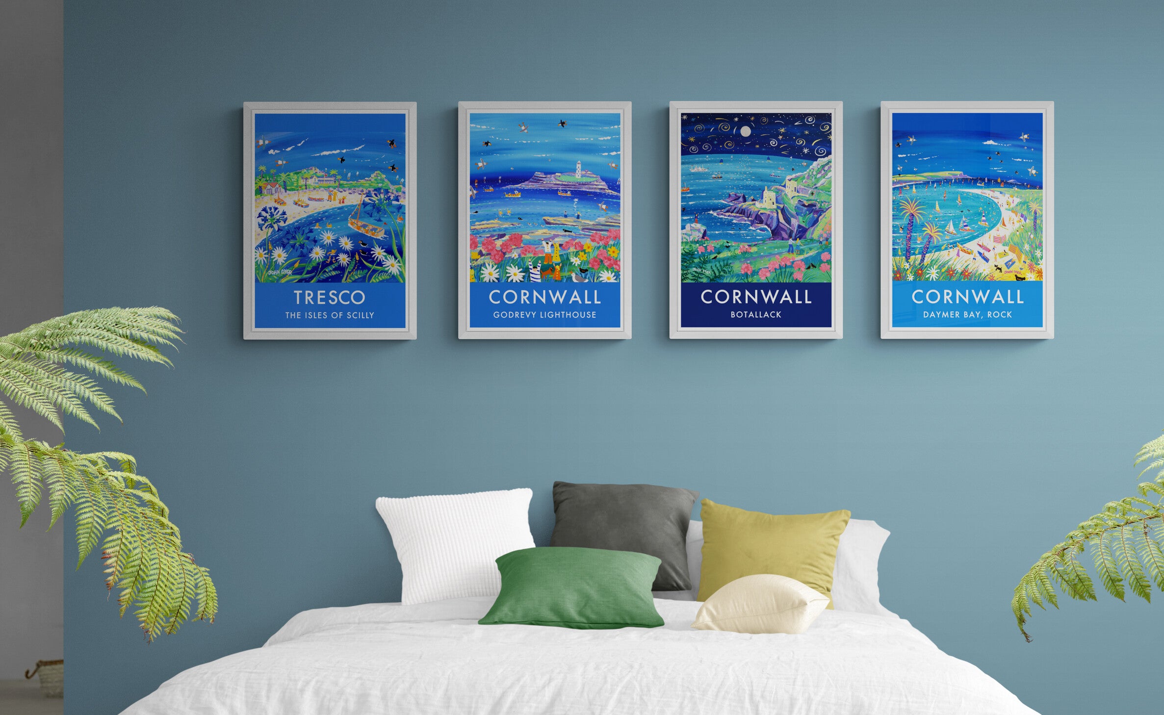 Seaside art posters displayed on a bedroom wall