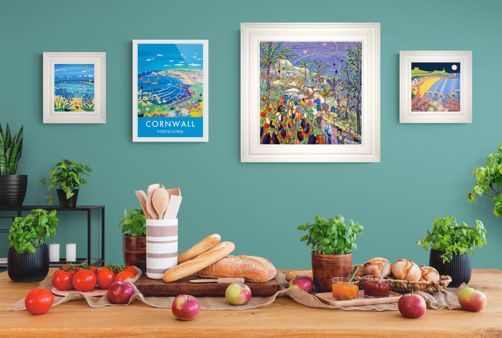 A group of paintings hanging on a kitchen wall