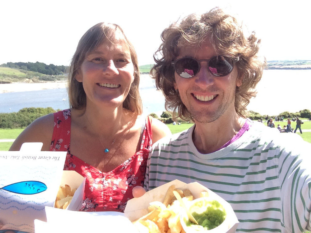Artists John Dyer and Joanne Short eating chips at Padstow, Cornwall