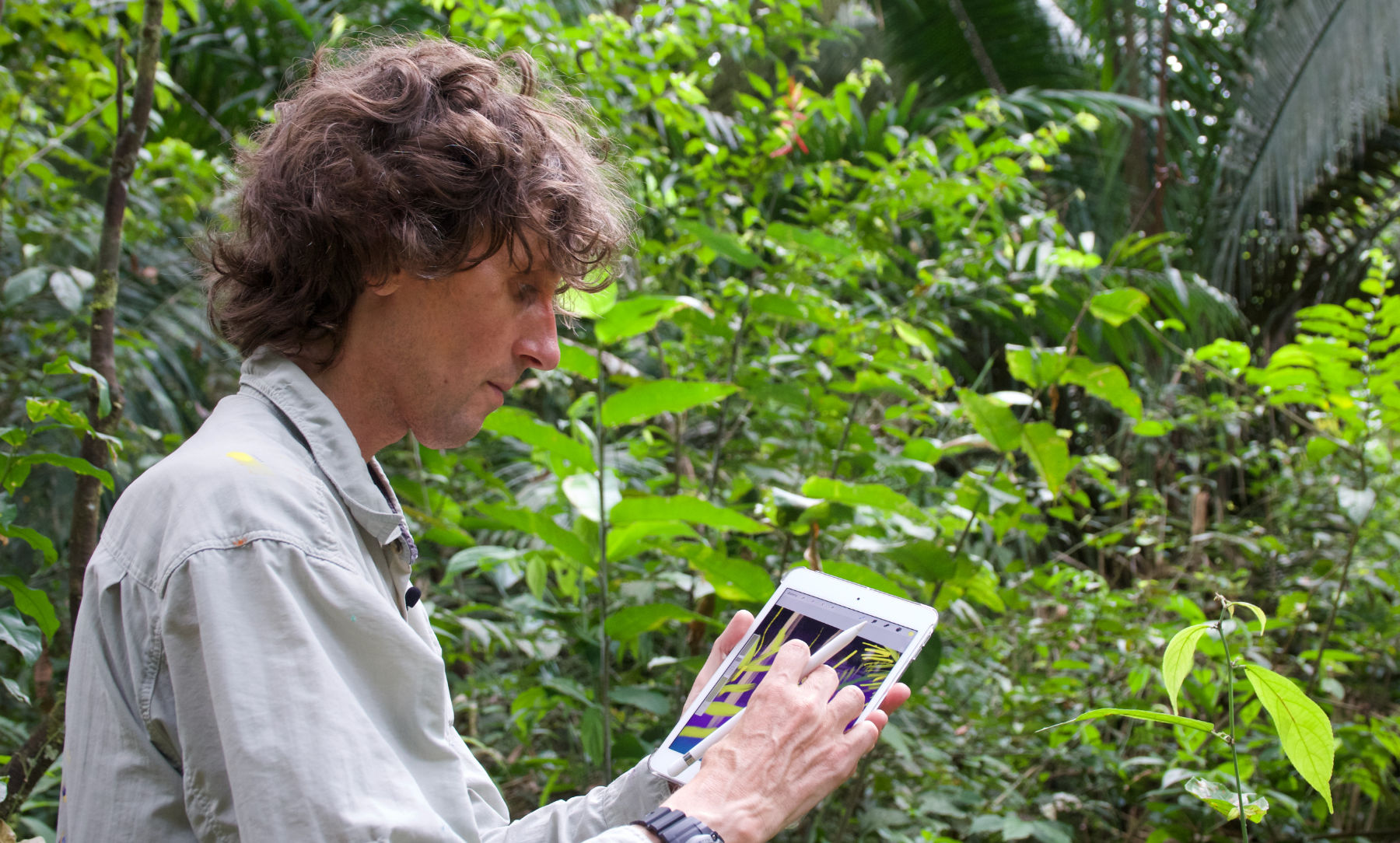 John Dyer seen drawing and painting on iPad mini in the Amazon rainforest of Brazil using the app Procreate.