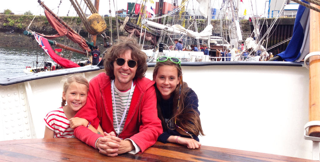 Artist John Dyer picture on a Tall Ship in 2014 with his two daughters, Wilamena on the left and Martha-Lilly on the right