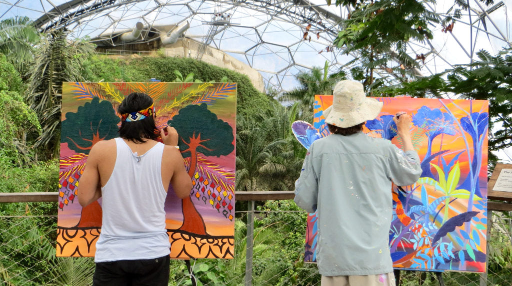 Amazon Indian Nixiwaka Yawanawá and environmental artist John Dyer painting in the rainforest biome of the Eden Project in May 2015