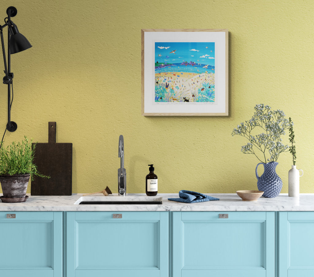Yellow and blue beach house kitchen with coastal wall art by John Dyer