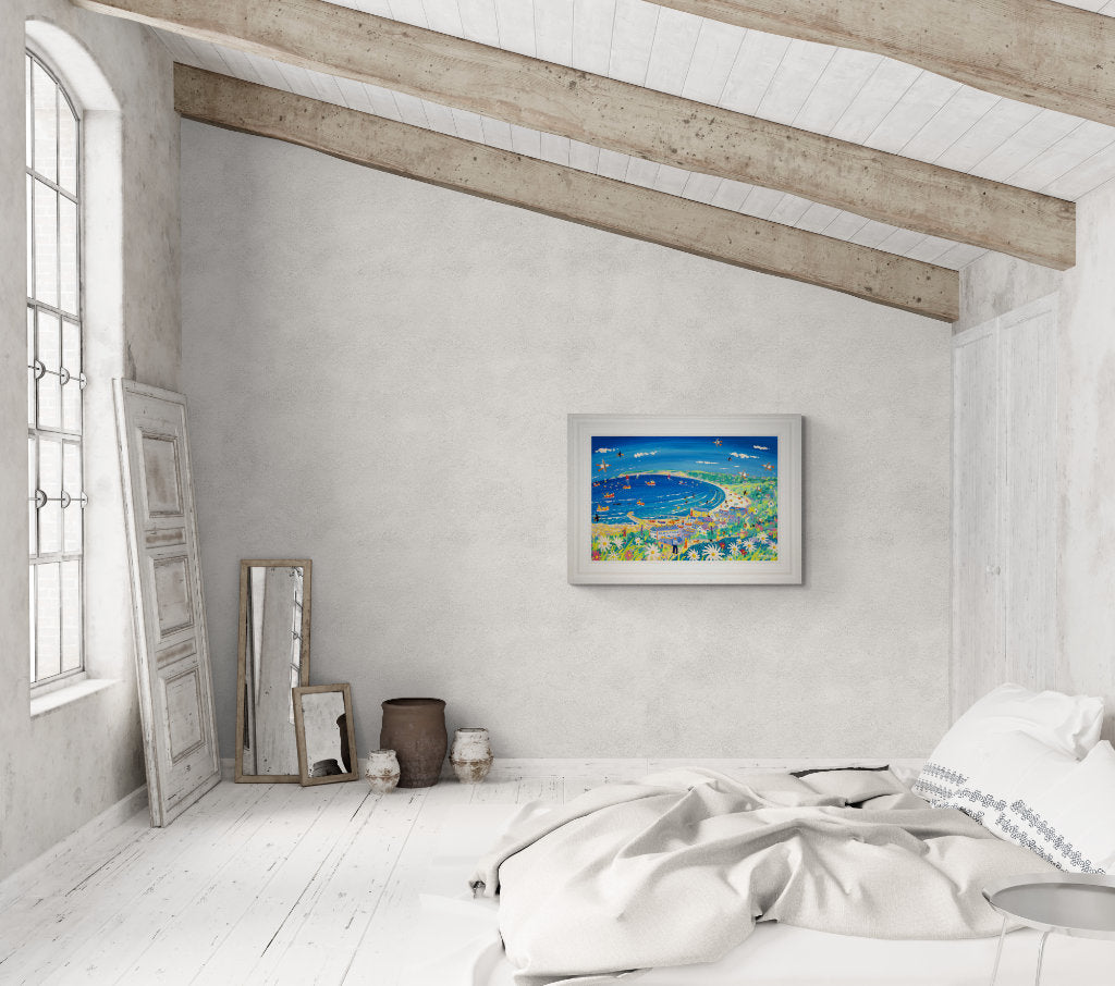 Beach house art in a bedroom setting with coastal wall art by Cornish artist John Dyer