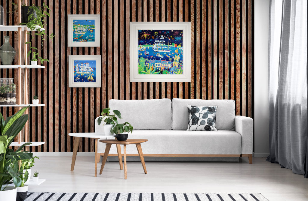 Beach house art on a shiplap wall with Cornish coastal art by John Dyer