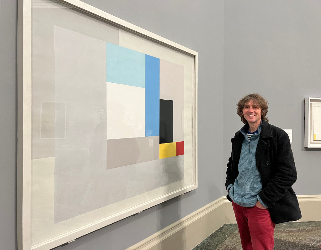 Cornish artist John Dyer at Tate Britain standing next to the painting 'June 1937' by Ben Nicholson