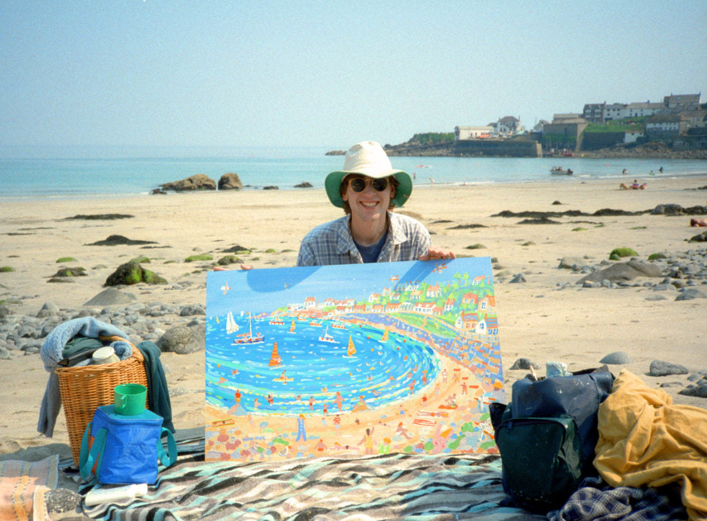 Cornish artist John Dyer pictured painting on the beach in Coverack, Cornwall