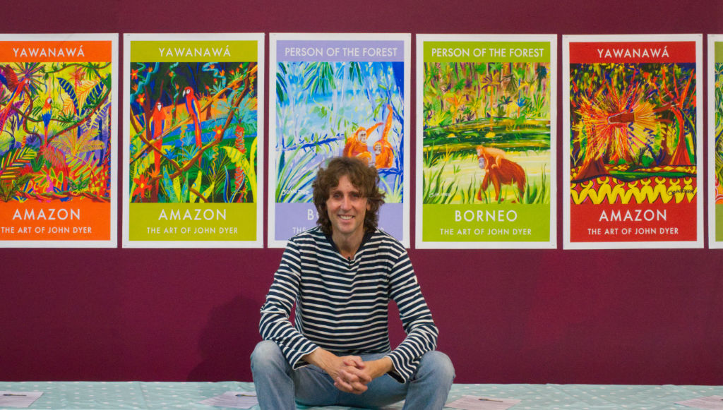 Cornwall artist John Dyer pictured in front of a series of his 'Last Chance To Paint' wildlife art poster prints at the Eden Project