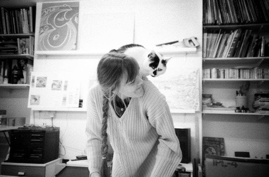 John Dyer's studio cat Jess on the back of artist Joanne Short