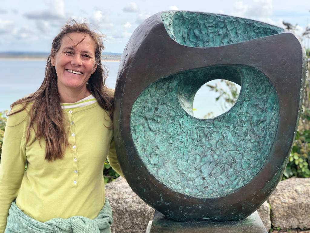 Artist Joanne Short pictured with a Barbara Hepworth sculpture in the town of St Ives in Cornwall