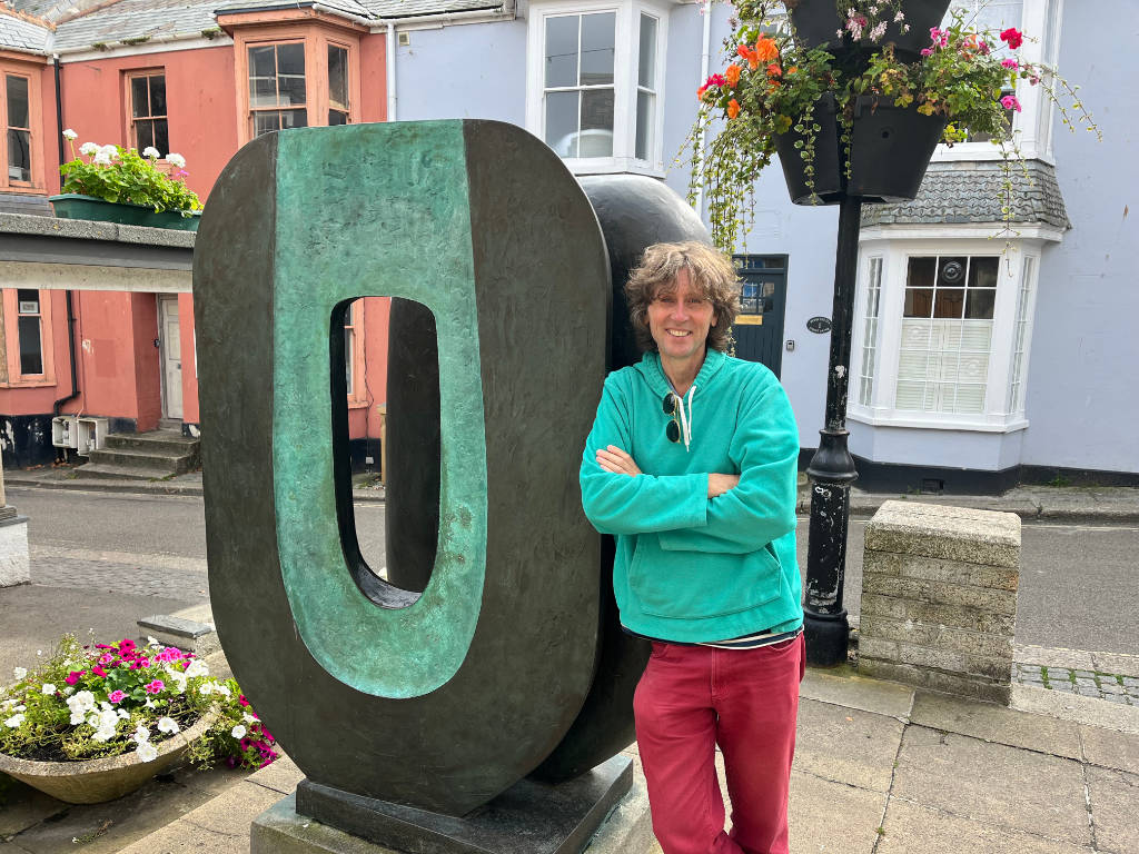 Artist John Dyer in St Ives, pictured next to a Barbara Hepworth sculpture