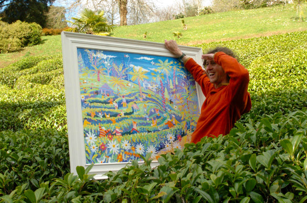 John Dyer pictured in the maze at Glendurgan garden with his painting 'Amazing Mayhem in the Maze in May, Glendurgan'.