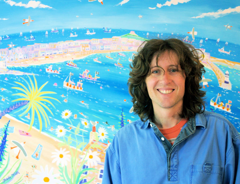 Cornish artist John Dyer pictured in his studio in front of one of his large canvases of St ives