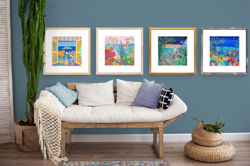 Framed signed limited edition prints displayed in a coastal beach home setting