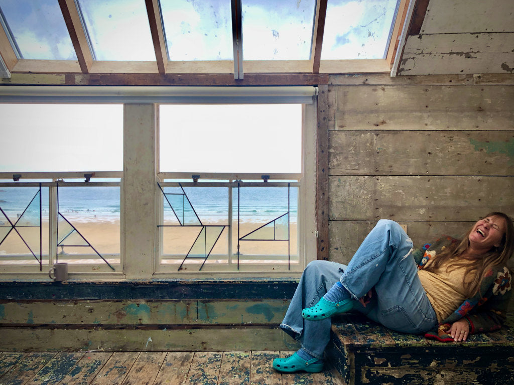 St Ives artist Joanne Short enjoying the atmosphere of the Porthmeor art studios in St Ives and the view to Porthmeor beach and the sea