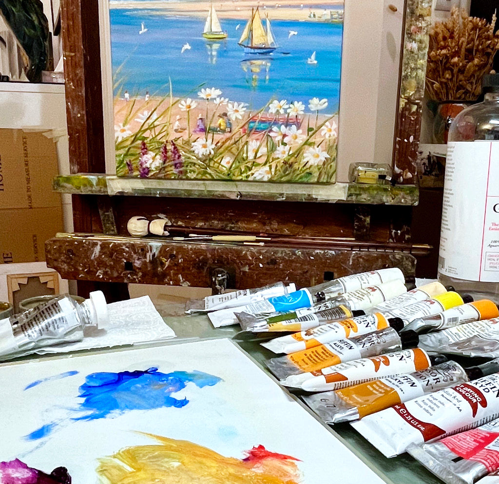 Ted Dyer's art studio with beach painting and art materials