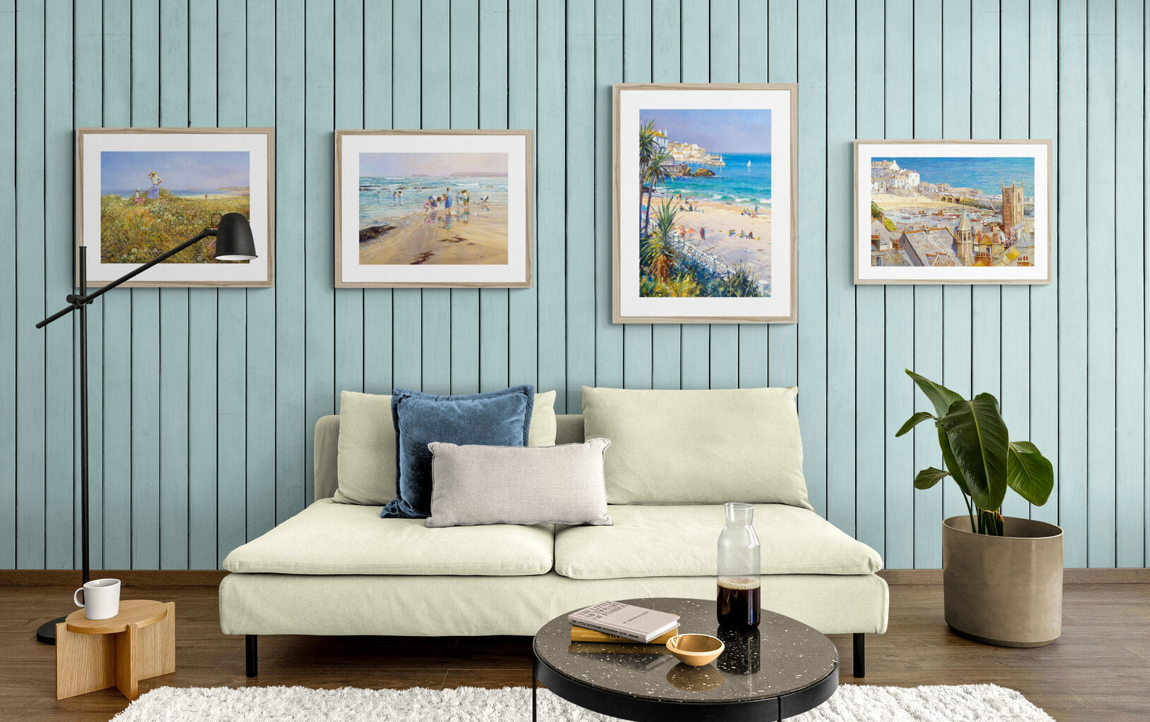 Collection of Ted Dyer coastal beach art prints of St Ives in Cornwall displayed on a wall