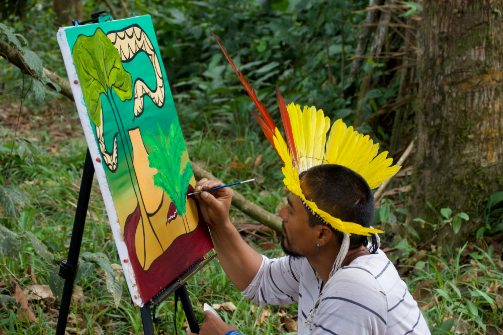 Amazon Indian artist Nixiwaka Yawanawá painting in the Amazon rainforest.