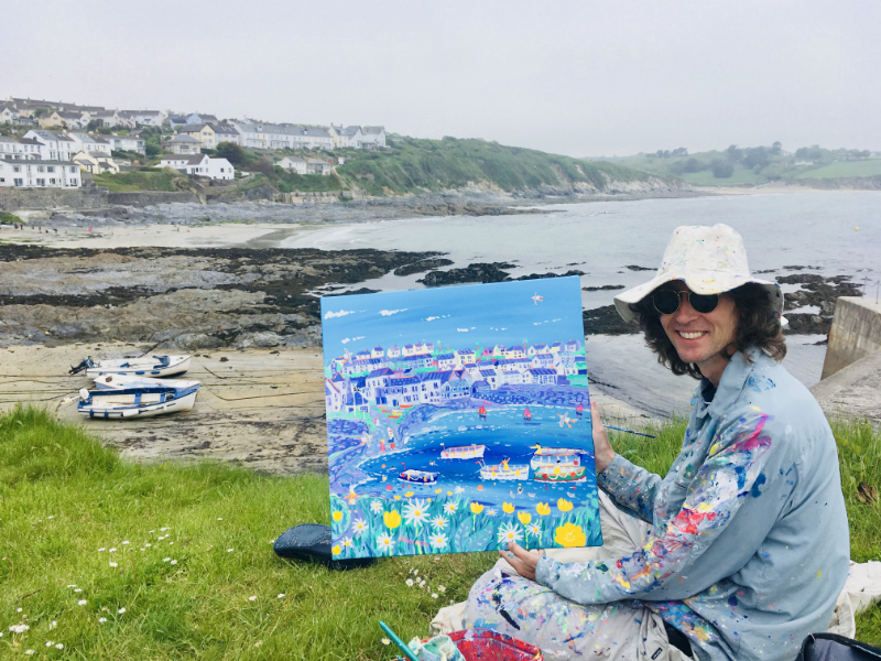 Artist John Dyer at work on his painting 'Summer Days, Portscatho' in the Cornish fishing village of Portscatho in Cornwall.