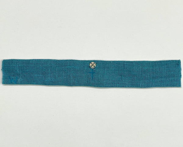 A blue strap with the ball side of a snap set sewn onto one side, 3/8" from the centerline.