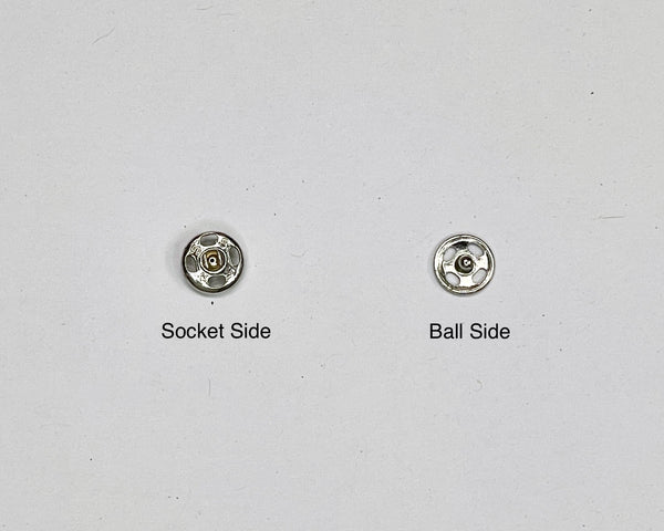 The two pieces of a snap set. The socket side labeled on the left, and the ball side labeled on the right.